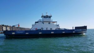 ferry boat on lake superior on dark blue water and bright blue sky