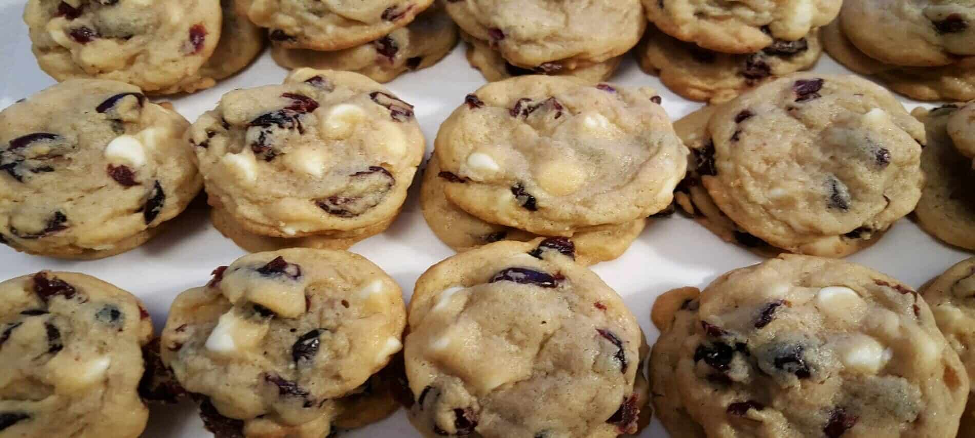 stacks of cookies with white chocolate chips and dried cranberries